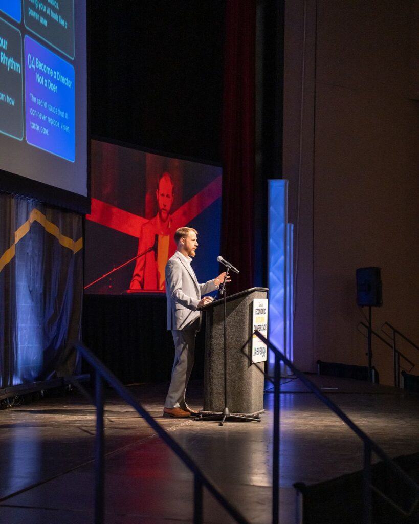 Miles Bassett presenting on stage at a Kansas business conference